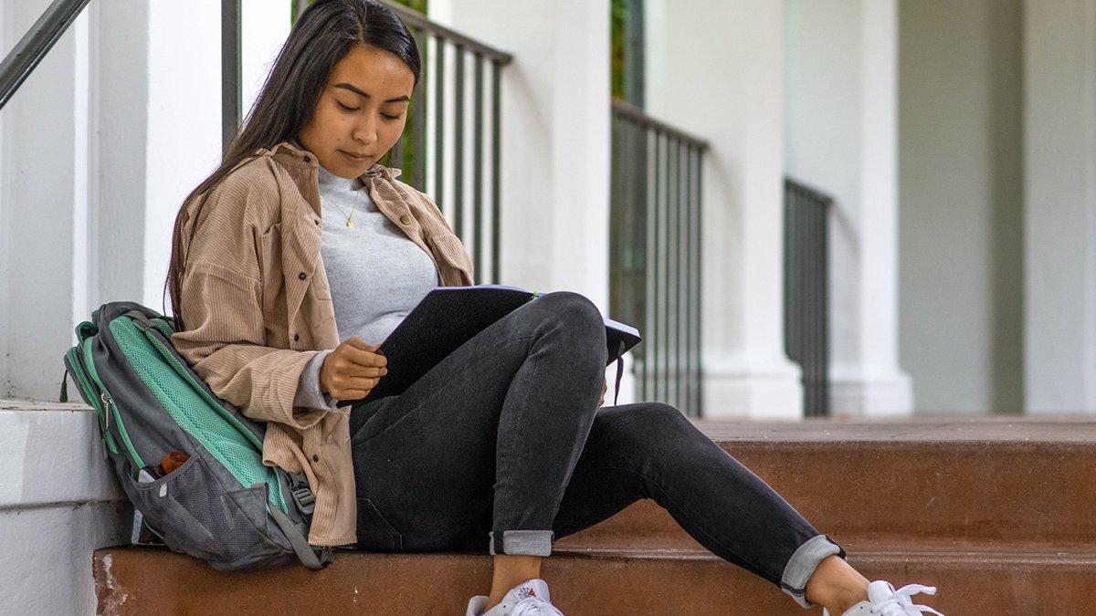 Student works on steps of SMC building